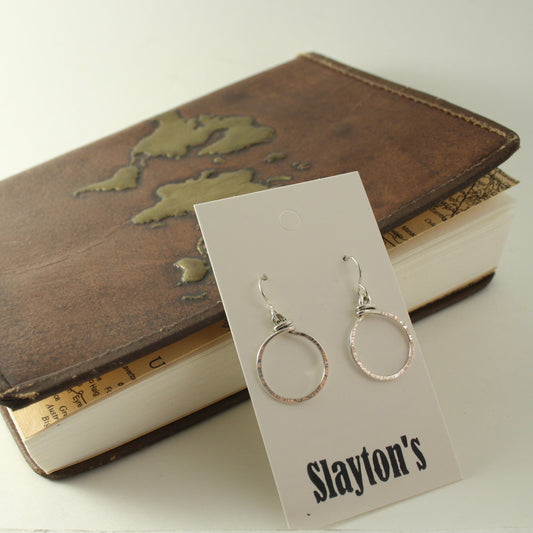 sterling silver earrings with a twisted forward facing hoop with hammer texture finish